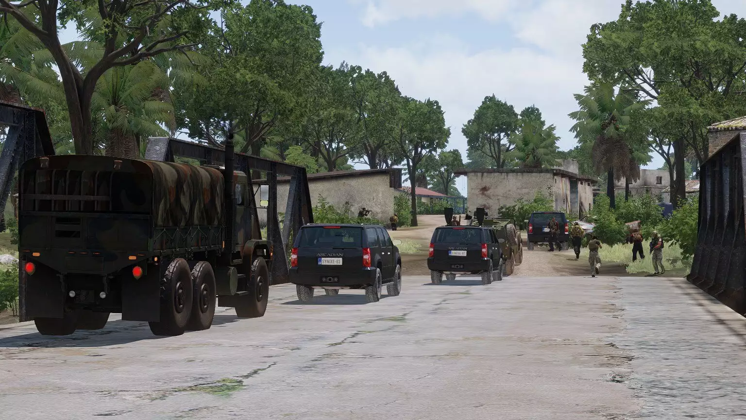 SUVs and a military truck cross a bridge